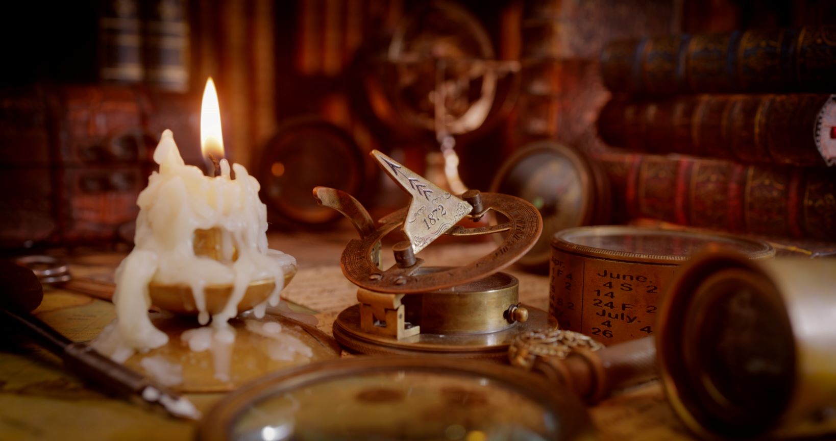 Antique alchemical desk with candle and books